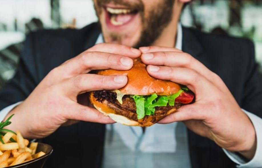 man eating burger