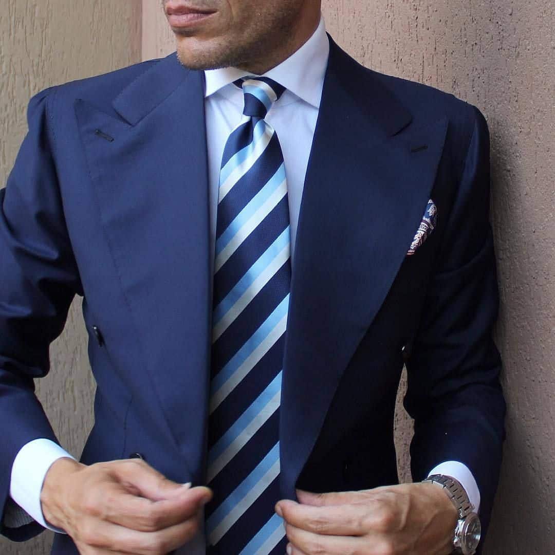 Blue suit with a white shirt and striped tie
