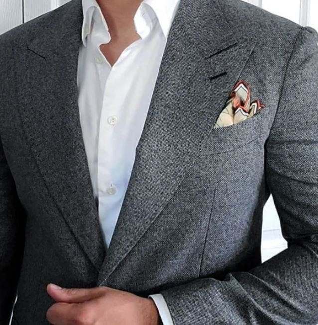 Grey suit with a white shirt and patterned tie
