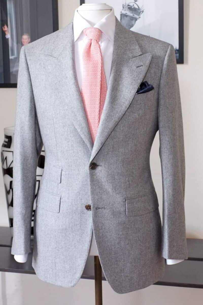 Grey suit with a white shirt and pink tie