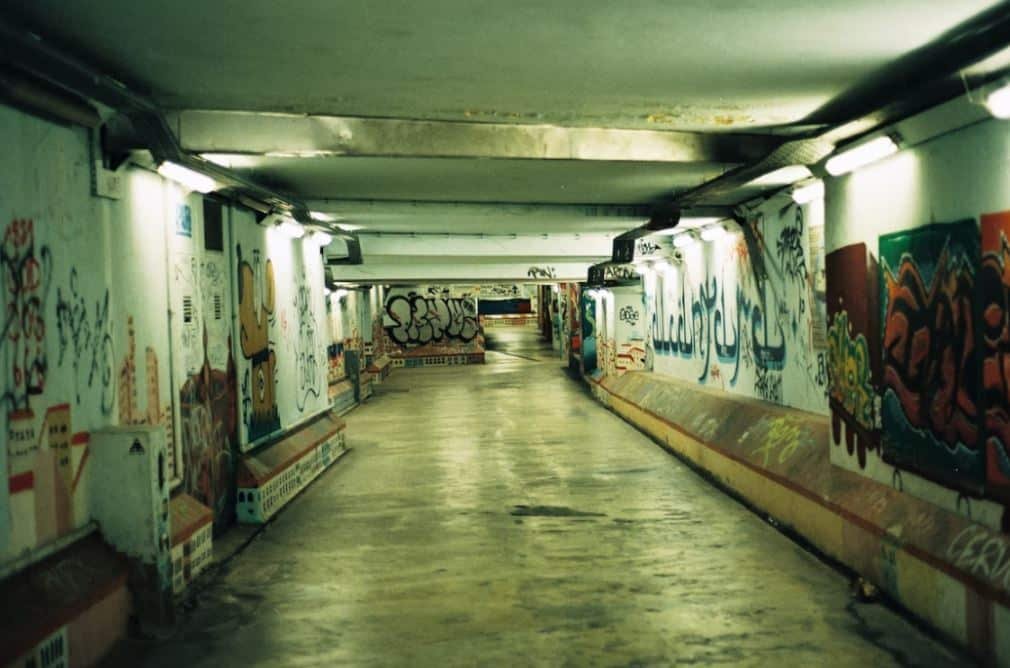 a hallway with graffiti on the walls
