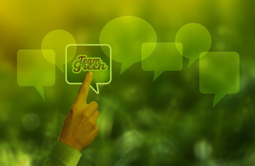 finger pointing to a chat bubble containing the words “Team Green”, denoting the commitment to sustainable business growth strategies