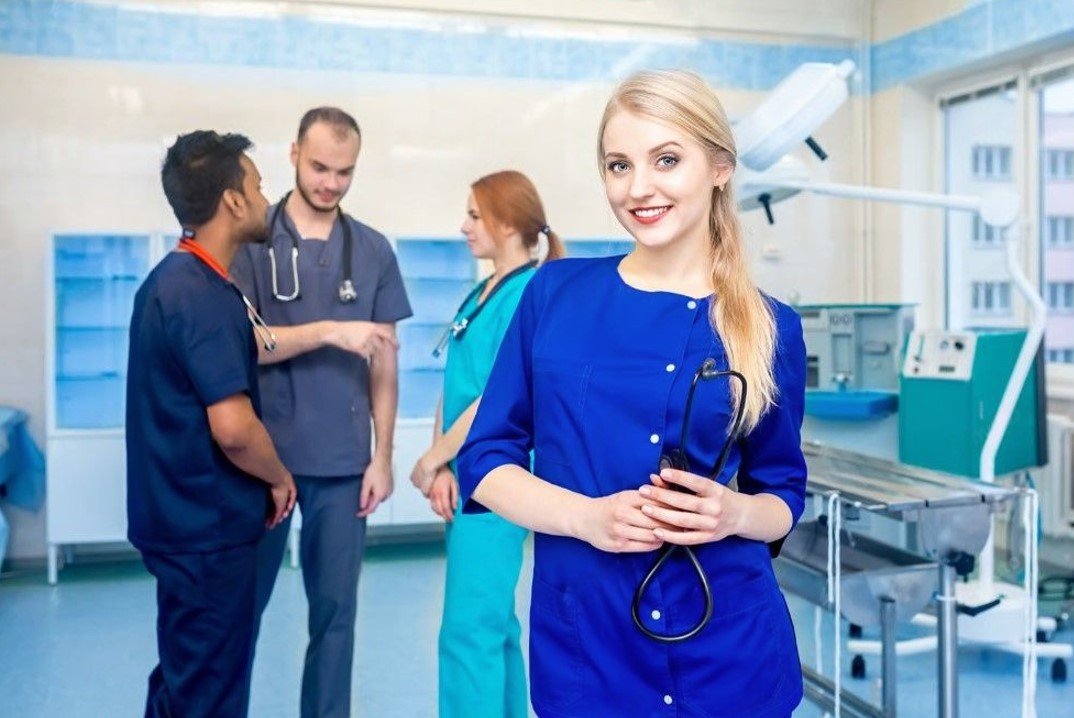 female doctor in front of team looking at camera